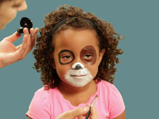 To accentuate the puppy nose in your Halloween makeup, use black face paint to make a small rounded triangle at the tip of the nose.