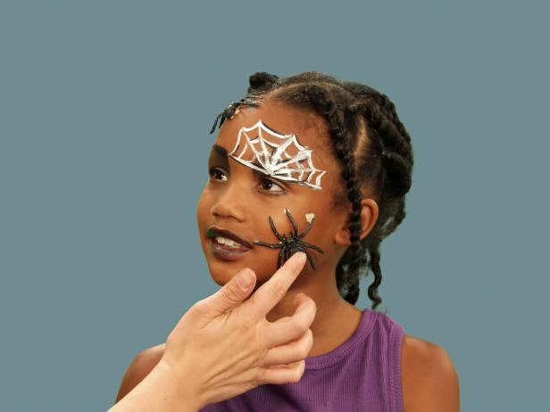 To make your spider makeup extra creepy, add several plastic spiders to the face in any size or shape. Liquid latex will keep them attached all night. Note: Be sure to test for any allergies first. Add as many spiders as you want for a spine-tingling effect.