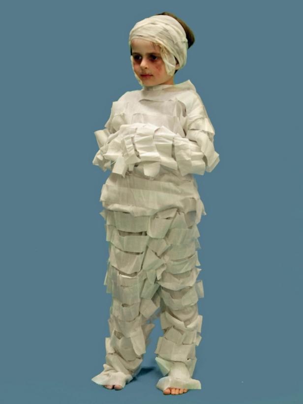 For the costume, use a store-bought version or create your own by gluing gauze to a white sweat suit.
