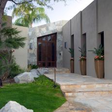 Modern Courtyard With Stone Focal Wall and Wood Door