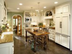 Off-white French Country kitchen with unique kitchen island. 