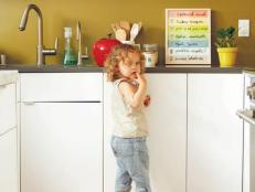 Kid on step stool in kitchen
