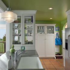 White, Glass-Fronted Cabinets in Green Transitional Kitchen