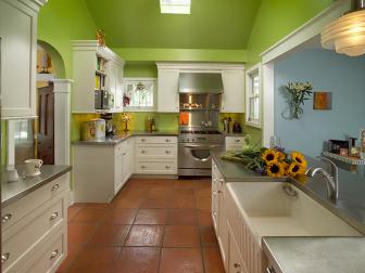 Green Kitchen With White Cabinets and Stainless Steel Countertops