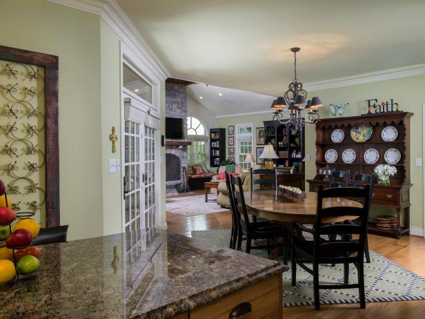 Wood Dining Table With Black Chairs Under Chandelier in Beige Room