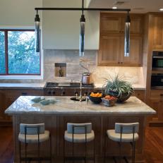 Contemporary Kitchen With Natural Countertops and Wood Finishes