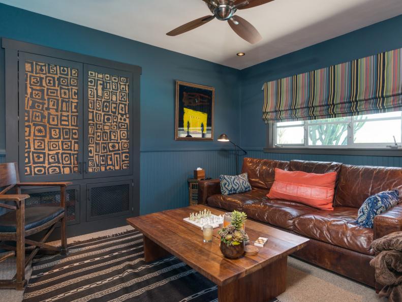 Living Room With Blue Walls and Patterned Accents