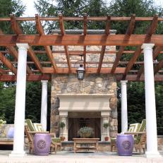 Outdoor Living Space With Pergola and Fireplace