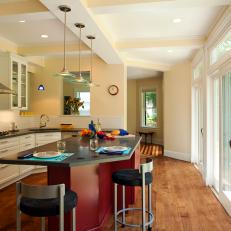 Contemporary Kitchen With Red Island and Beamed Ceiling