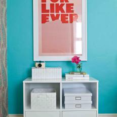 Turquoise Bedroom With Red Poster and White Cabinet