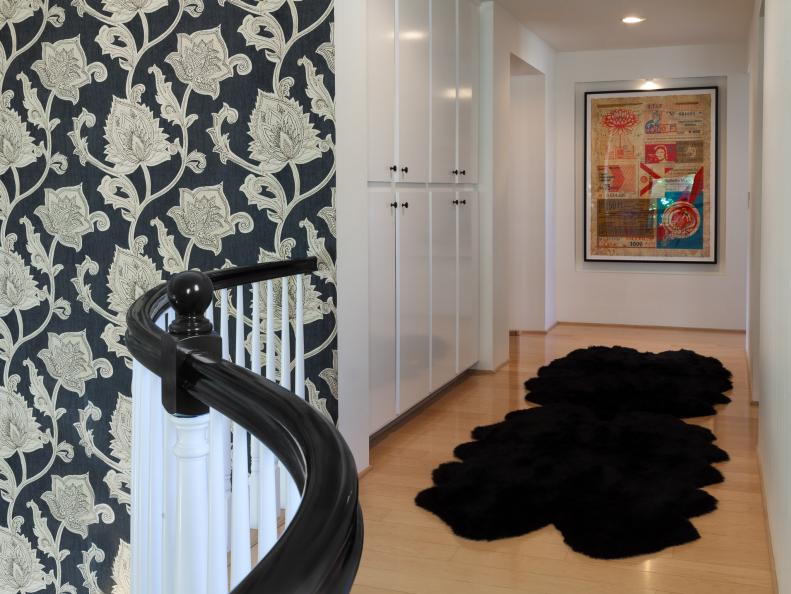 White Hallway With Black Faux Fur Rug and Patterned Wallpaper
