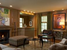 Traditional brown living room with bar area, fireplace & abstract art