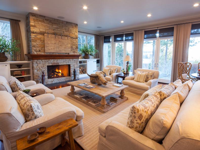 Living Room With White Sofa and Chairs and Stacked-Stone Fireplace