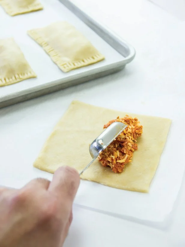 Add 2-1/2 tablespoons of filling to one side of the center of each pastry cutout leaving about 1/2 inch at the top, side and bottom of the pastry.