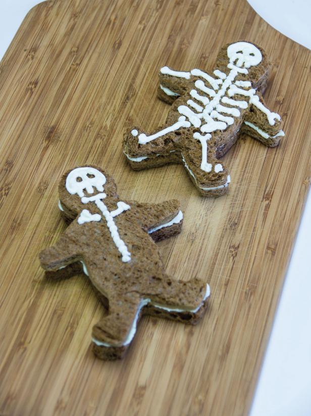 I scream, you scream, we all will scream on Halloween with these delicious scream cheese sandwiches. A finishing touch transforms gingerbread man cut-outs into spooky skeletons.