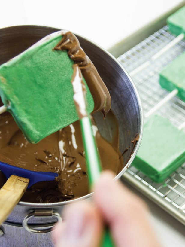 These delightful treats take a favorite campfire dessert and make it a Halloween delight!  To make Frankenstein's do- use a chopstick or skewer to remove any excess chocolate. Use the tip of the chopstick to indicate bangs by pulling some of the chocolate further down onto the green coating.