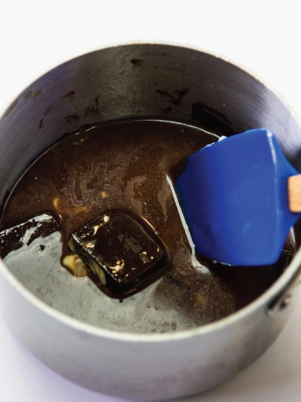 Melt butter and chocolate together in a small saucepan over medium low heat. Set aside to cool completely before proceeding.