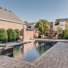 Stone and Brick Outdoor Patio With Swimming Pool