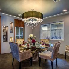 Contemporary Dining Room With Velvet Chairs and Chandelier