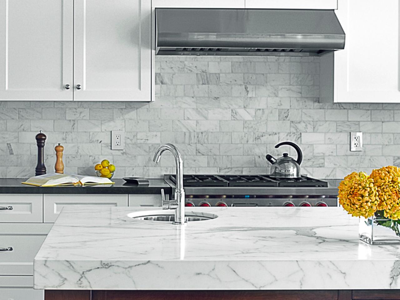 Gray Kitchen Island With Statuary Marble Countertops transitional white kitchen is bright timeless