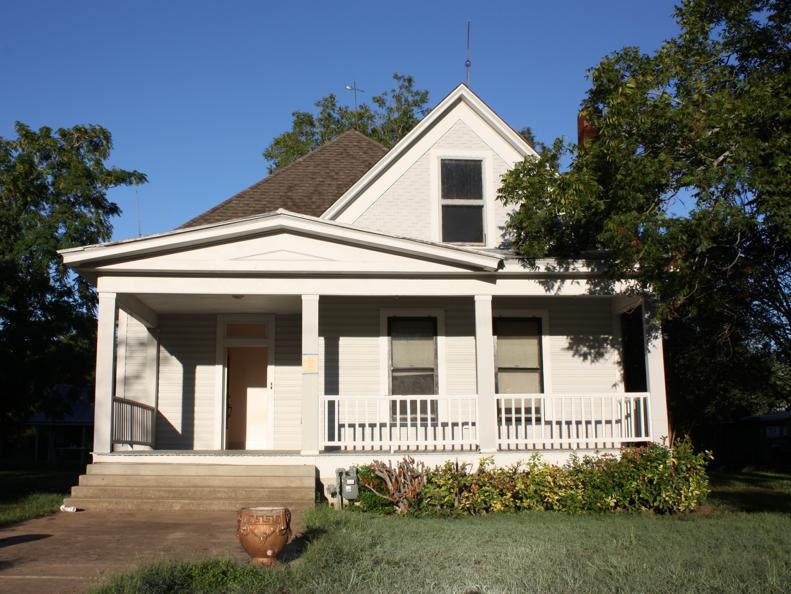 Exterior of White Home With Front Porch & Concrete Walkway