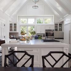 White Kitchen With Vaulted Ceiling and Dark Hardwood