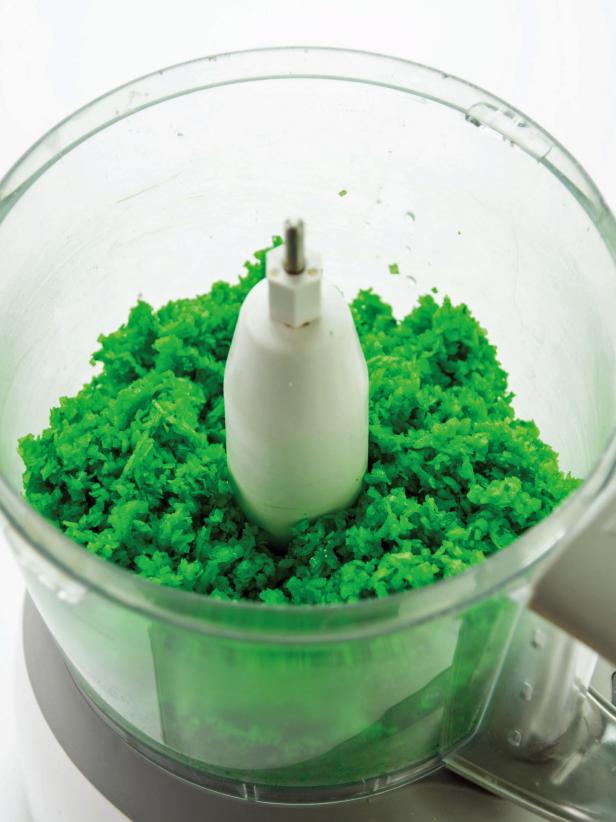 Place coconut and food color in a food processor.