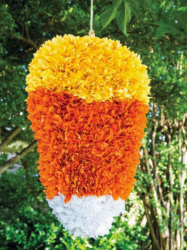 Halloween swings into action with this candy corn piñata. Your party guests will love taking a shot at this treat-filled craft. Because you make it yourself, you get complete control over what goes inside.