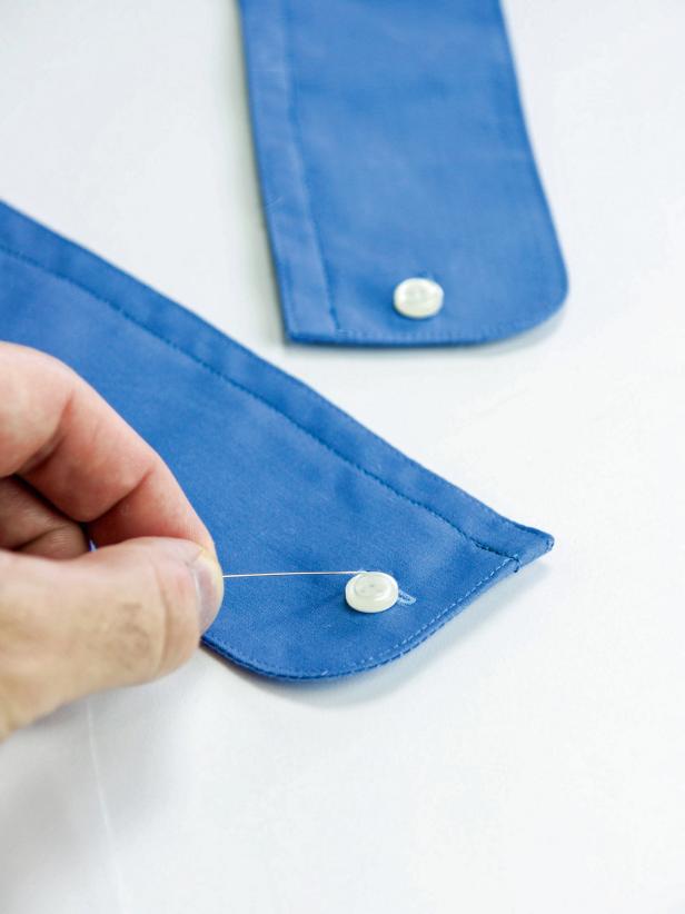 Using a needle and thread, sew a button to the button hole on each cuff.