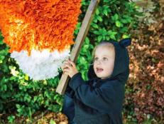 Halloween swings into action with this candy corn piñata. Your party guests will love taking a shot at this treat-filled craft. Because you make it yourself, you get complete control over what goes inside.