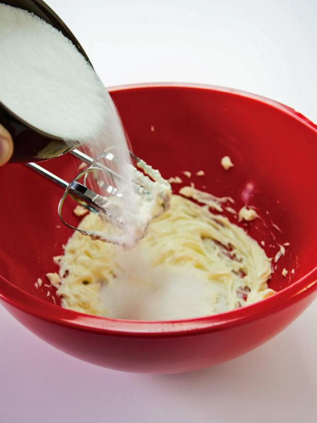 In a large bowl beat butter untill smootha nd creamy.  Ass remaining 1 cup of sugar.