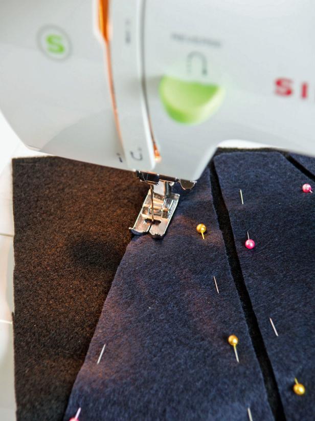 Use a sewing machine with charcoal thread to sew in place.