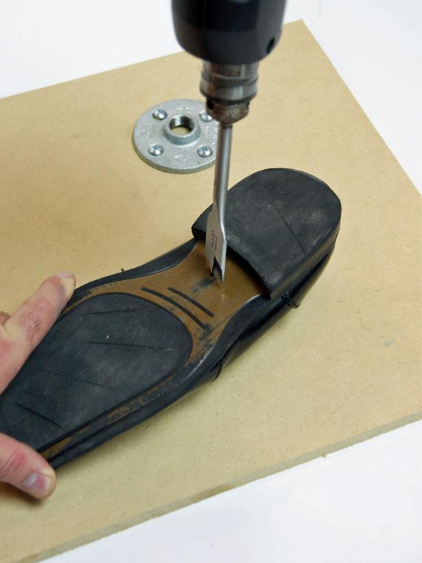 Using a 1-1/8” drill bit, drill a hole in the bottom of the shoe just in front of the heel.