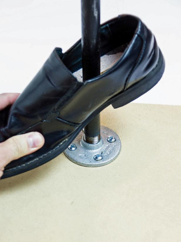 f you encounter a metal shank inside the sole of the shoe remove it with a pair of pliers. Attach the galvanized pipe to the floor flange and slide the shoe over the pipe using the new hole.