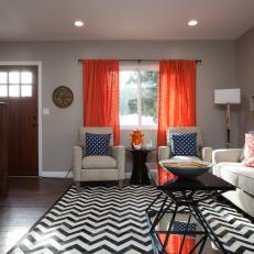 Taupe Living Room With Orange Curtains and Chevron Rug