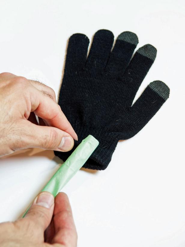 Roll sheets of tissue paper up tightly and insert into gloves as fingers.