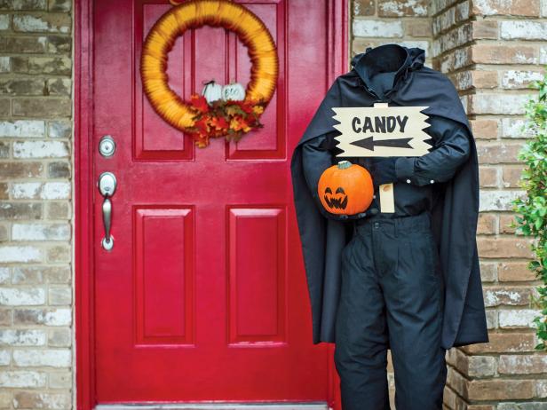 Add some spooky to your steps with this creepy door greeter. The sign tells guests where to find the candy.