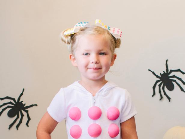 Hot glue them onto the cover up. Create hair bows using real candy dots.