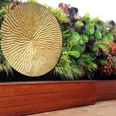 Vertical Living Wall with Oversized Medallion Scul