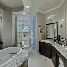 Gray Spa-Like Bathroom With Black & White Granite Countertops