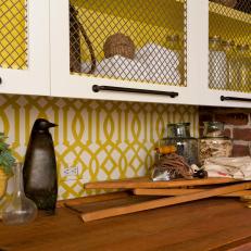 Cottage Laundry Room With Yellow Trellis Wallpaper and Mesh Cabinets 