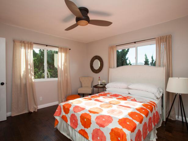 neutral mid century modern bedroom with patterned bedding