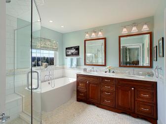 A double vanity bathroom with white counter tops. 