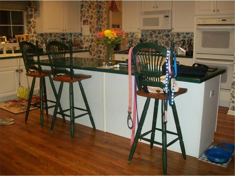 Before the makeover, this kitchen was dark and dated, with a floral wallpaper that overpowered the space.
