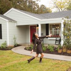 Joanna Gaines in Front of White Home Exterior