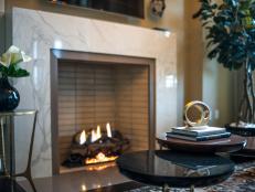 Modern furnishings, warm hues and a Carrera marble fireplace set the tone for a chic design style.