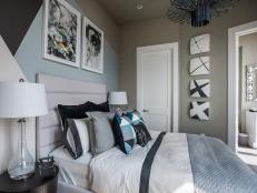 A geometric focal wall and decorative artwork are striking features in this urban bedroom retreat.