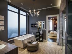Floor-to-ceiling windows, a glass-enclosed shower and luxurious soaking tub offer a spa oasis with stunning views of Atlanta's cityscape.