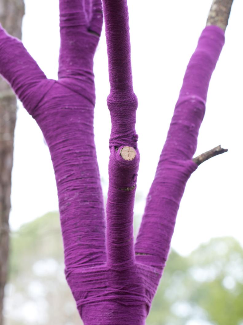 Tree wrapped in purple yarn