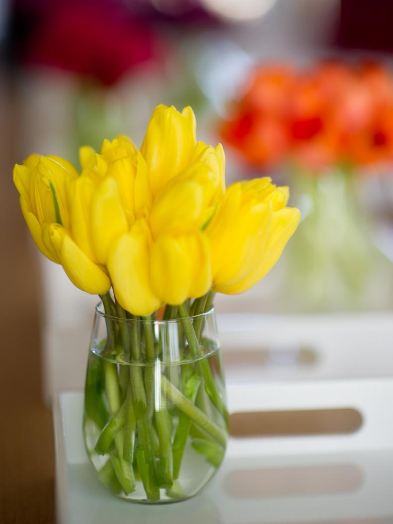 The talented team at The Byrd Collective helped create these centerpieces. To make your own, choose bright colors as the
foundation for your decor, and buy a dozen tulips or carnations in each of those shades.